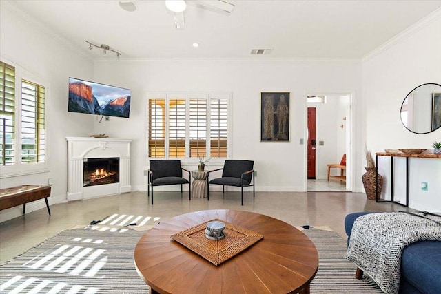 living room with ceiling fan and ornamental molding