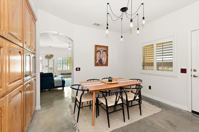 dining room with ceiling fan with notable chandelier