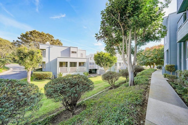 exterior space with a front lawn and stucco siding