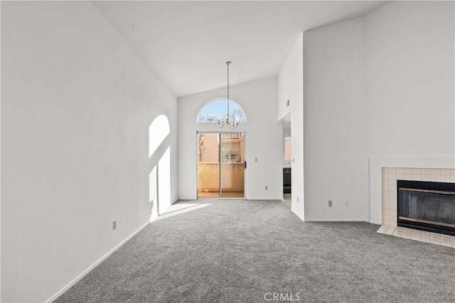 unfurnished living room featuring high vaulted ceiling, carpet, a chandelier, and a fireplace