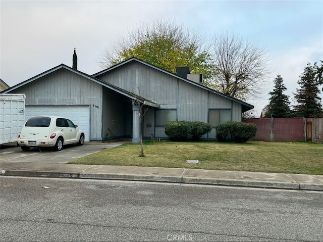 single story home featuring a front yard and a garage