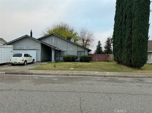 ranch-style house featuring a front yard and a garage