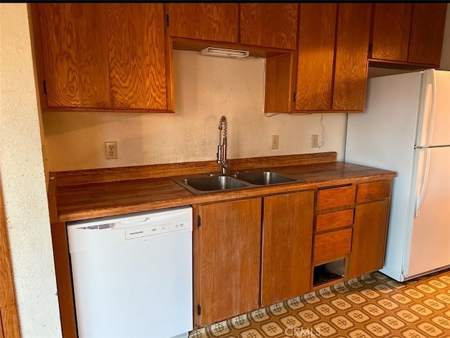 kitchen with sink and white appliances