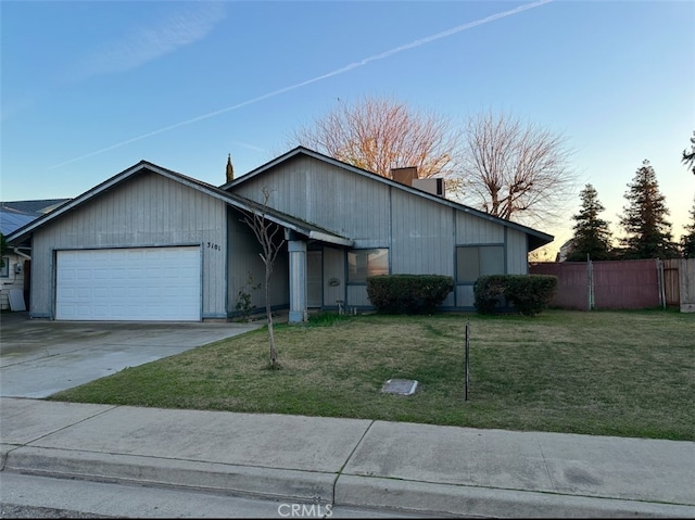 view of front of home with a lawn and a garage