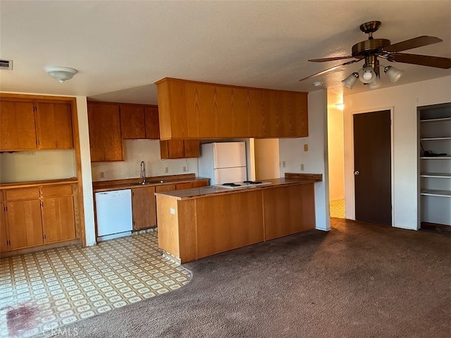 kitchen with white appliances, light carpet, sink, kitchen peninsula, and ceiling fan