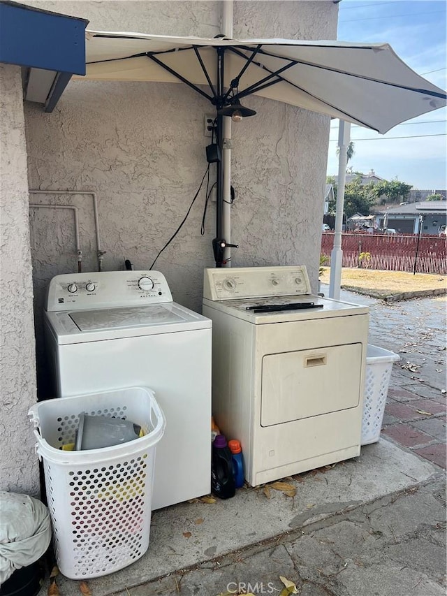 laundry area with independent washer and dryer