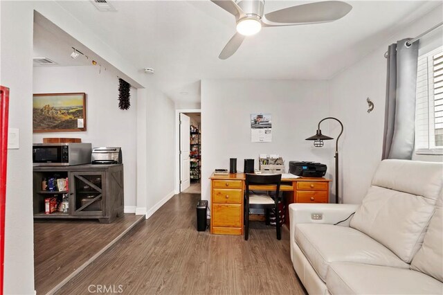 home office featuring ceiling fan and hardwood / wood-style floors