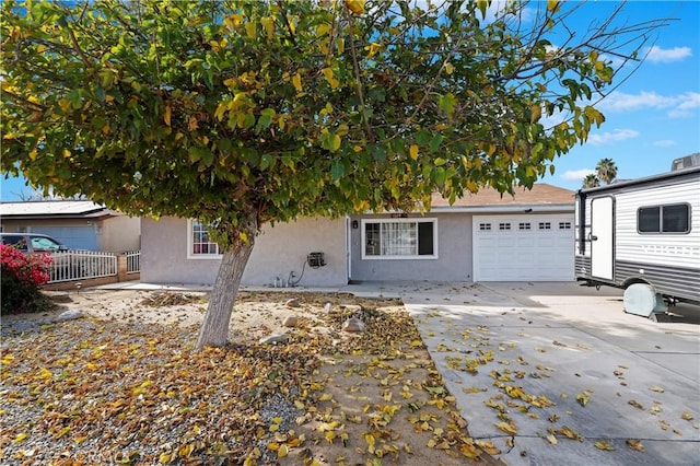 view of property hidden behind natural elements featuring a garage