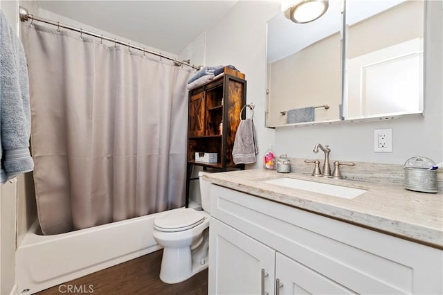 full bathroom featuring toilet, hardwood / wood-style floors, vanity, and shower / bath combo with shower curtain