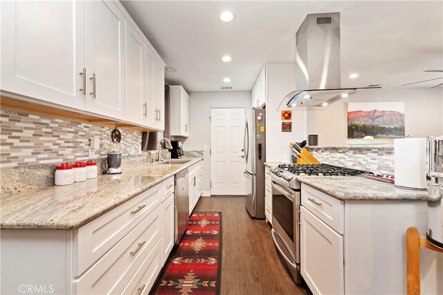 kitchen with white cabinetry, island exhaust hood, appliances with stainless steel finishes, dark wood-type flooring, and sink