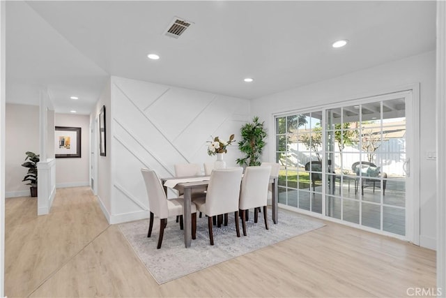 dining space with light hardwood / wood-style flooring