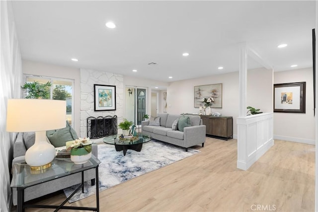 living room with light hardwood / wood-style floors and a fireplace