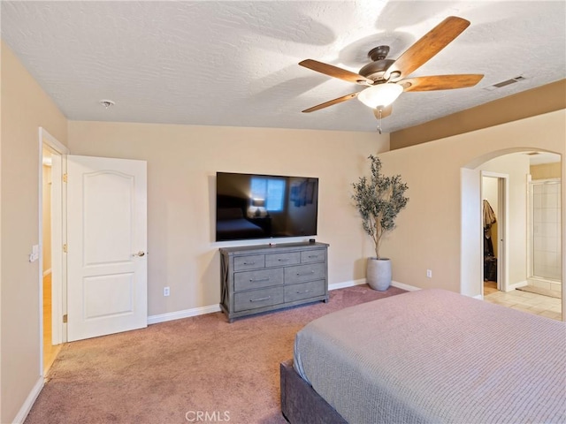 bedroom with ceiling fan, a textured ceiling, and light carpet