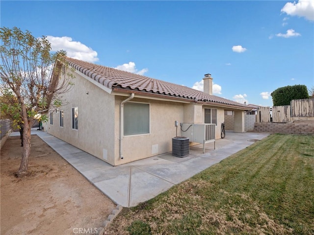 rear view of house featuring a patio area and a yard