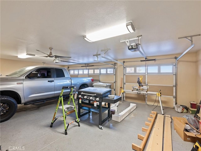 garage featuring ceiling fan and a garage door opener