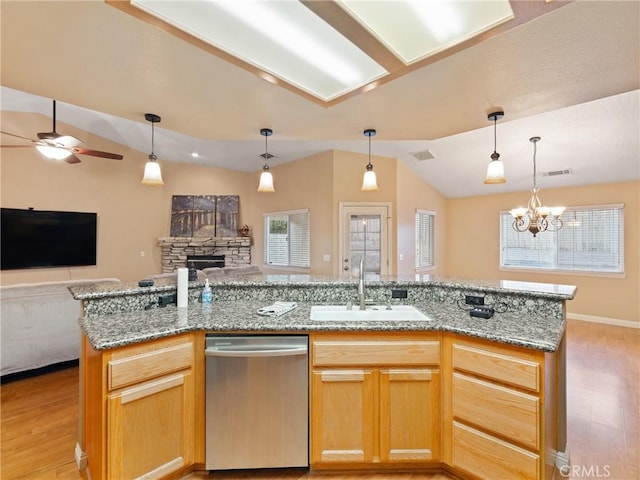 kitchen featuring stainless steel dishwasher, sink, light hardwood / wood-style flooring, a kitchen island with sink, and ceiling fan with notable chandelier