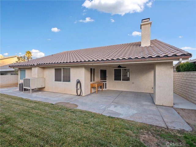 rear view of house featuring a patio area, a yard, and ceiling fan