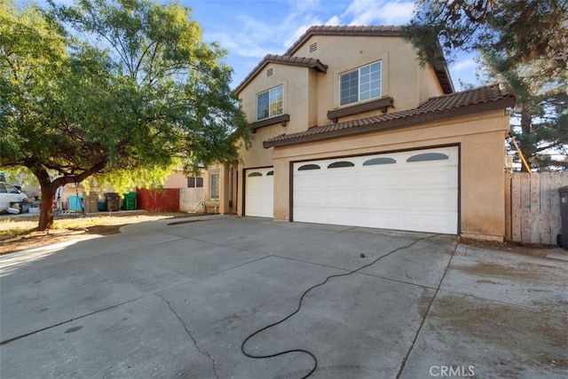 mediterranean / spanish house with a garage