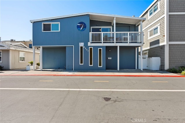 view of front of house with a garage and a balcony