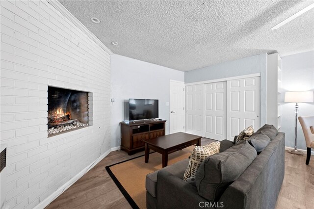 living room featuring a textured ceiling and light hardwood / wood-style floors