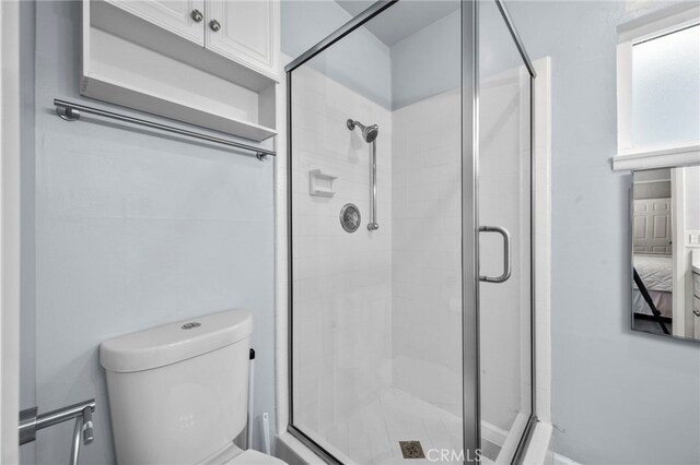 bathroom featuring toilet and walk in shower