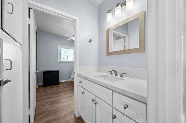 bathroom featuring hardwood / wood-style flooring, vanity, and ceiling fan