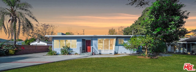 view of front of home with a yard