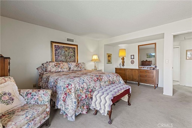 carpeted bedroom featuring a textured ceiling