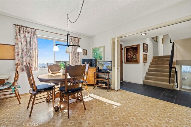 dining area featuring a textured ceiling