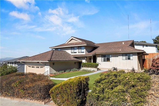 view of front of home featuring a garage and a front lawn