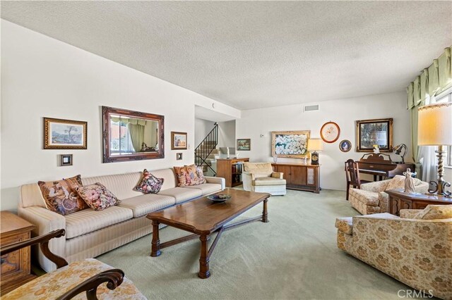 living room with carpet floors and a textured ceiling