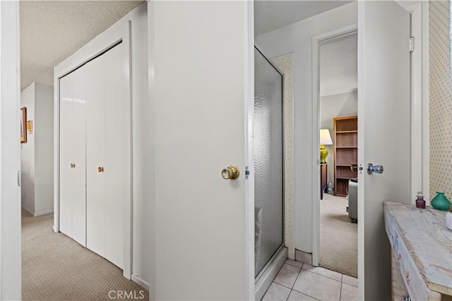 bathroom featuring a shower with door and tile patterned flooring