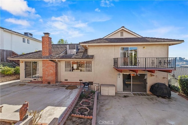 rear view of property featuring a patio area, central air condition unit, and a balcony