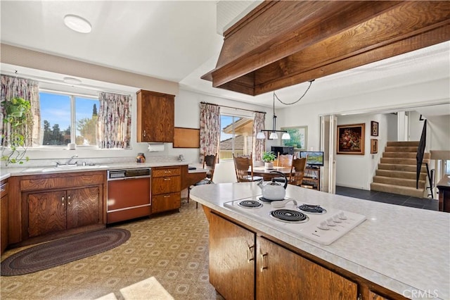 kitchen featuring dishwasher, white electric cooktop, and sink