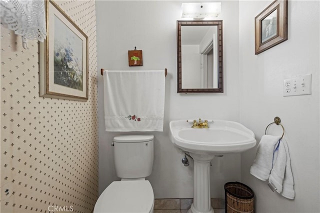 bathroom featuring tile patterned floors and toilet