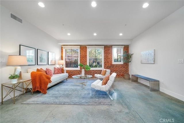 living room with brick wall and concrete flooring