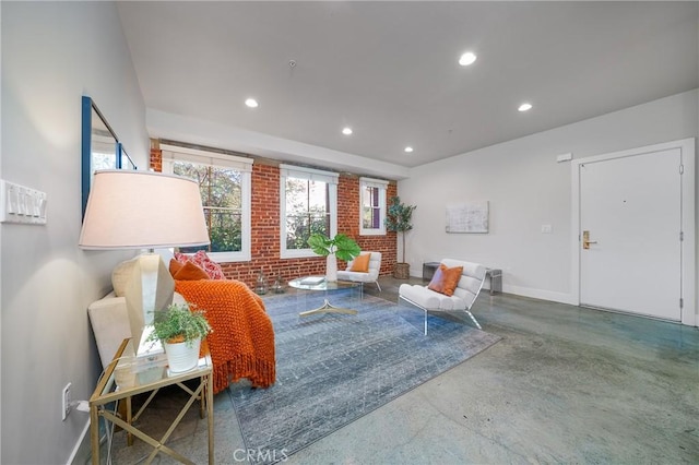 living area with brick wall and concrete floors