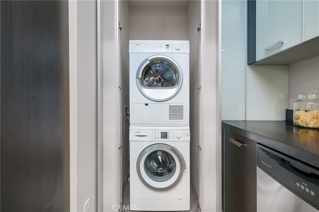 clothes washing area with stacked washer / drying machine