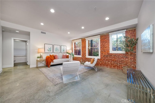 living room featuring brick wall