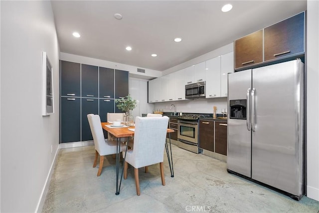 kitchen featuring white cabinets, sink, stainless steel appliances, and dark brown cabinetry