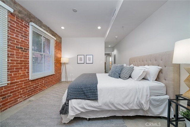 bedroom featuring brick wall