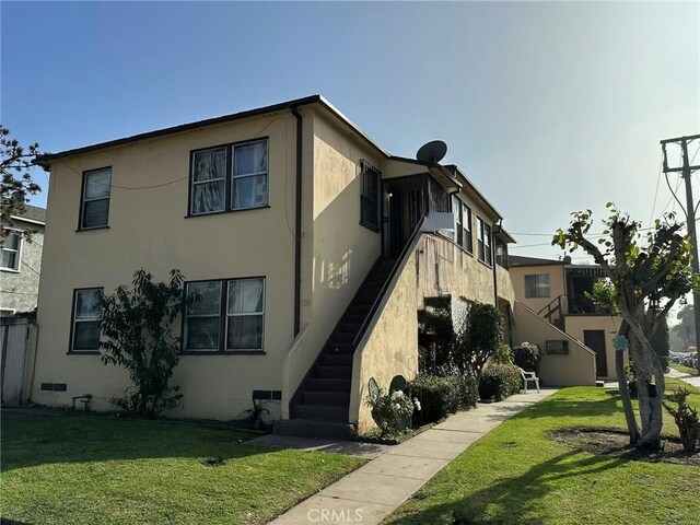 view of side of property with a lawn