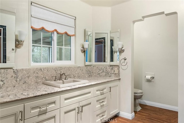 bathroom with vanity, hardwood / wood-style floors, and toilet