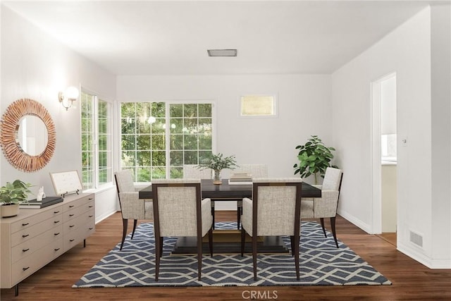 dining area with dark hardwood / wood-style flooring