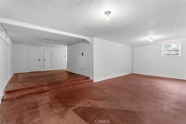 unfurnished room with a textured ceiling