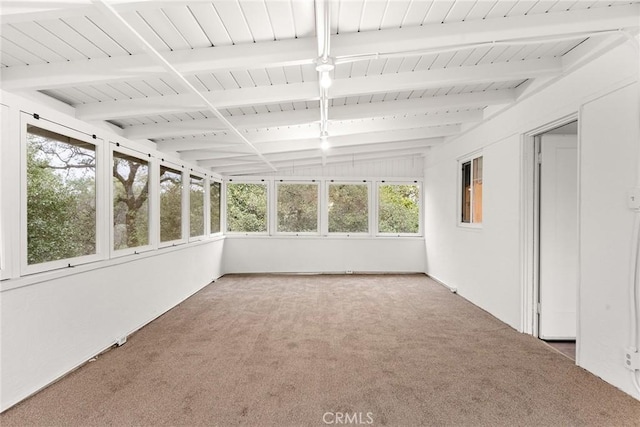 unfurnished sunroom featuring beamed ceiling and wooden ceiling