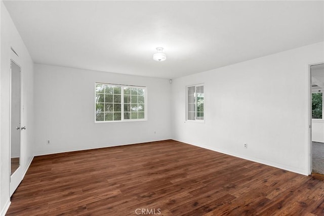 empty room with dark hardwood / wood-style floors