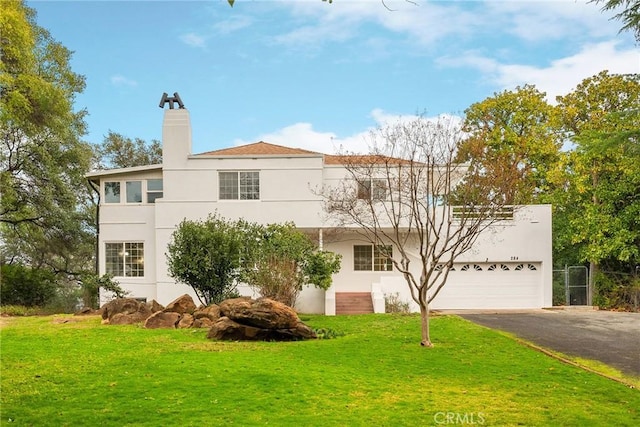 view of front of home with a garage and a front yard