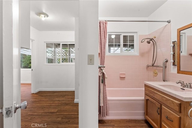 bathroom featuring vanity, hardwood / wood-style floors, and shower / bath combo with shower curtain