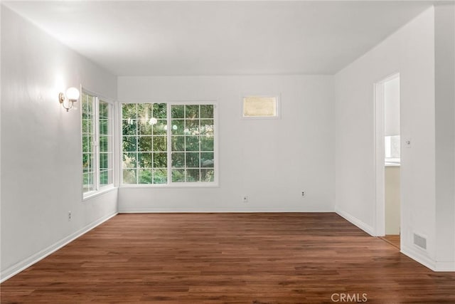 unfurnished room with dark hardwood / wood-style floors